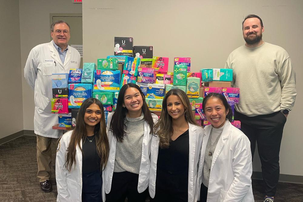 An image of OUWB student in front of products collected