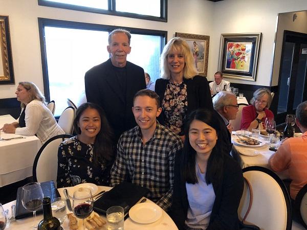 Students attend a dinner with a doctor event. They're sitting at a table together.