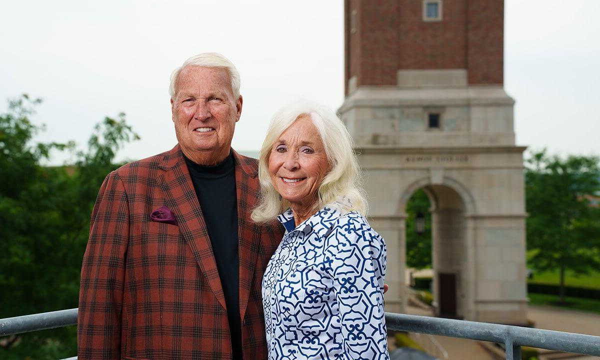 Hugh and Nancy Elliott stand together in front of Elliott Tower